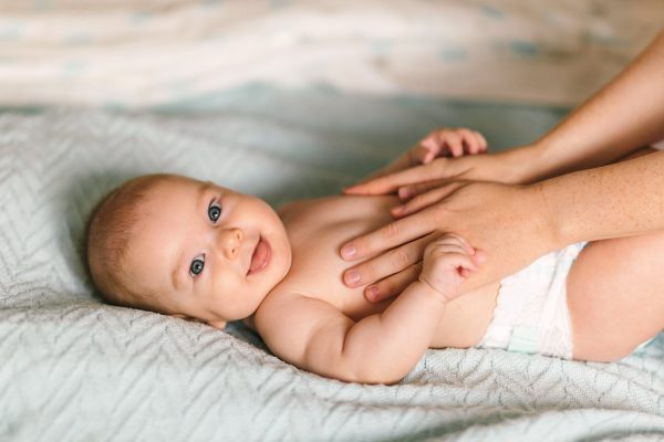 Massage for the baby. Four month old baby smiling